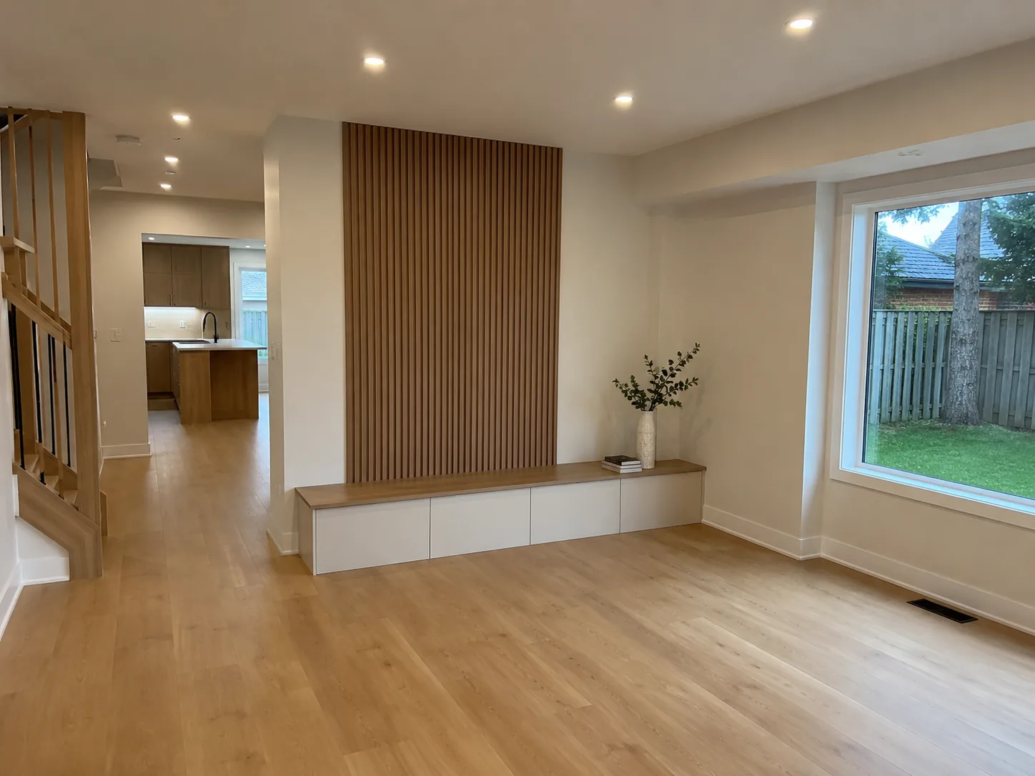 Open living space with wood slat feature wall and built-in bench